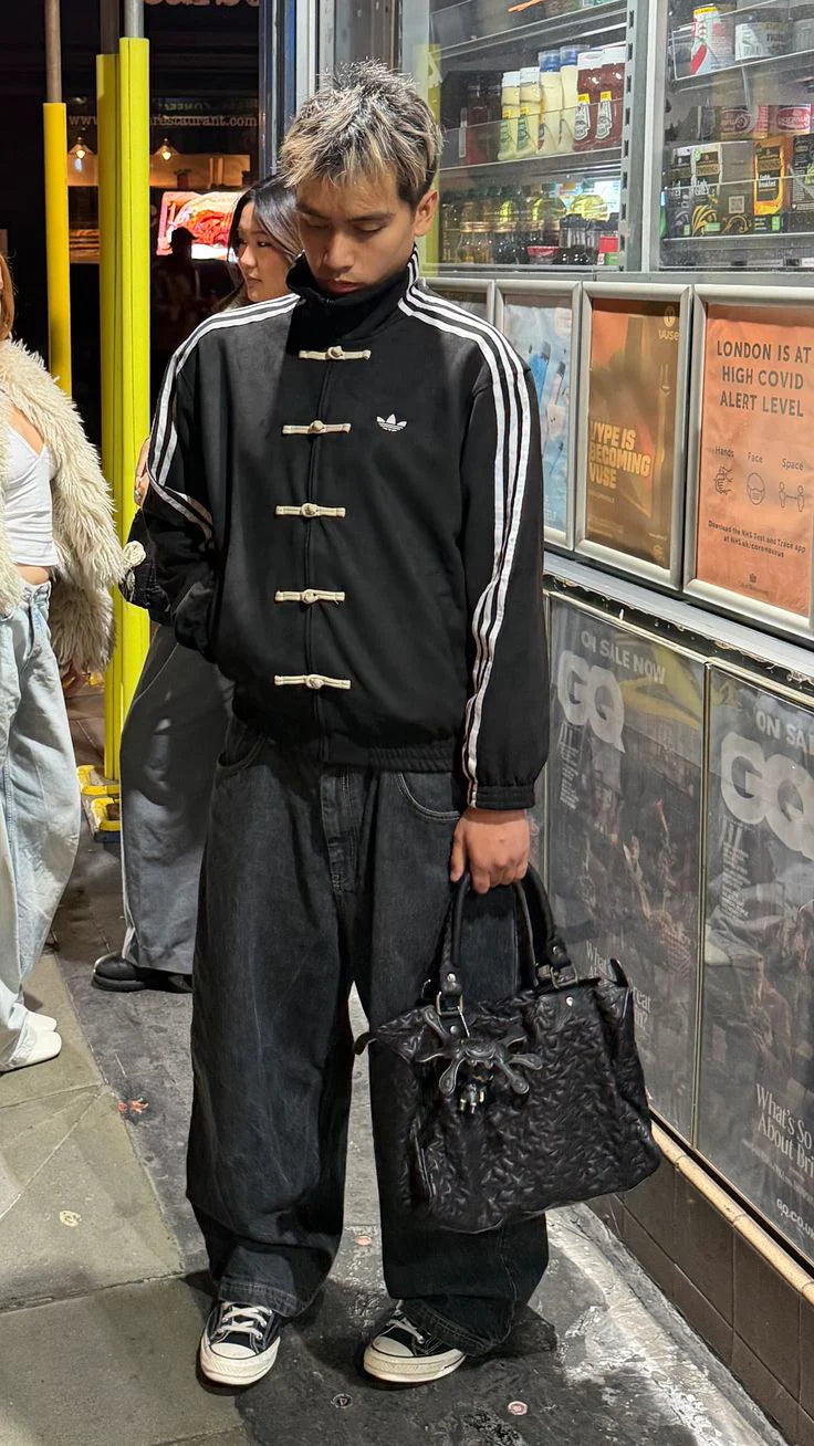 Black fusion streetwear jacket with striped sleeve detailing
